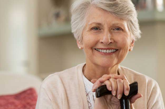Smiling woman with cane